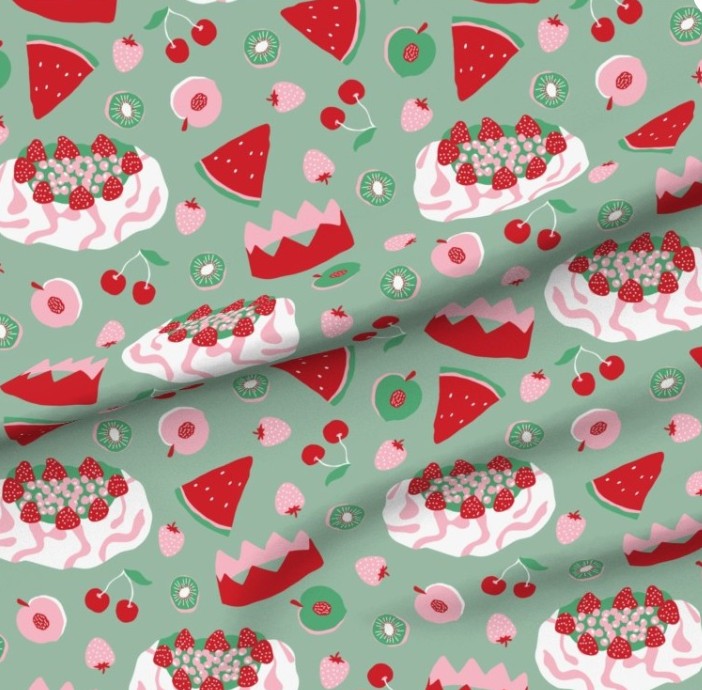 Patterned fabric with cakes, watermelons, and cherries on a green background