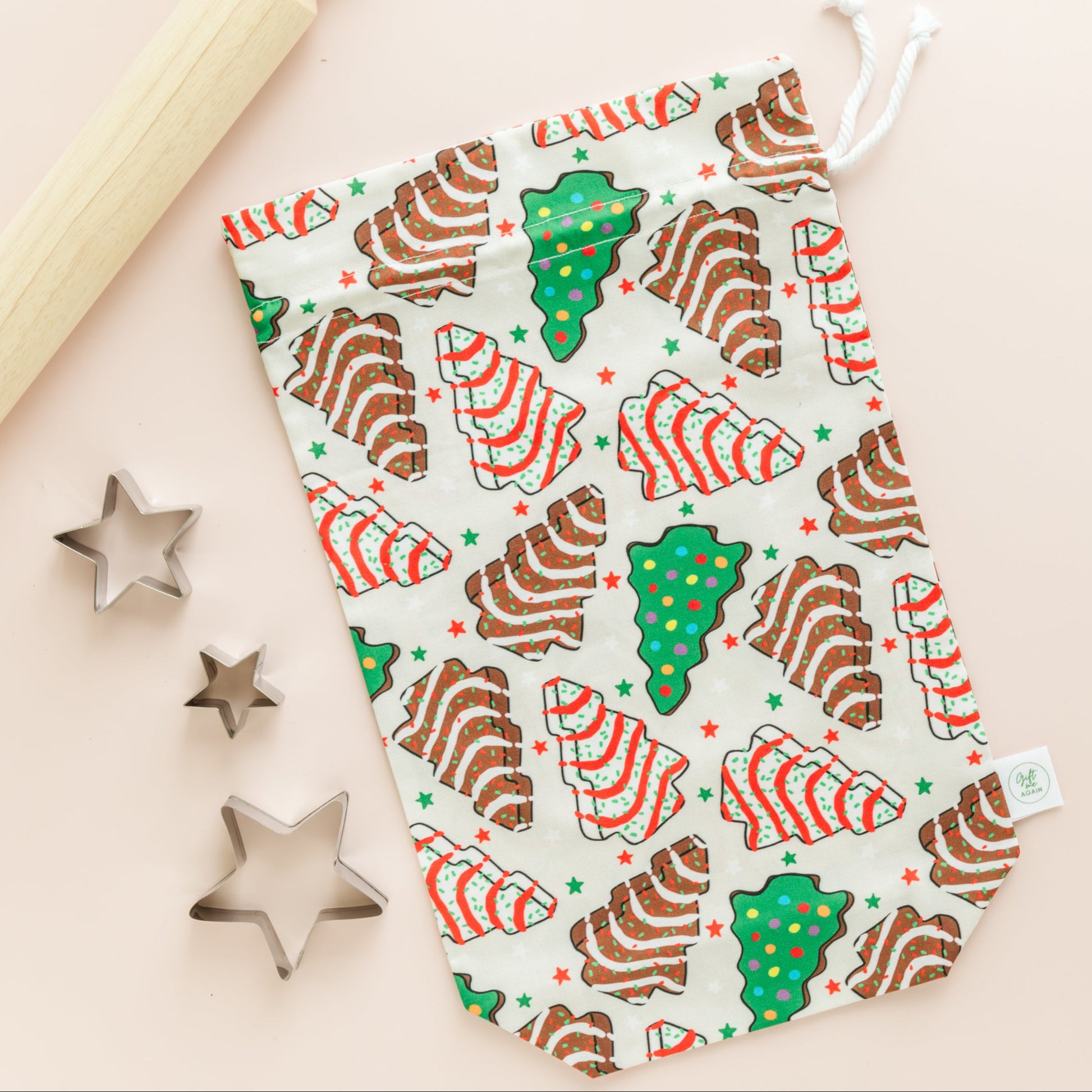 Fabric gift bag with with Christmas tree cookie pattern on a beige background