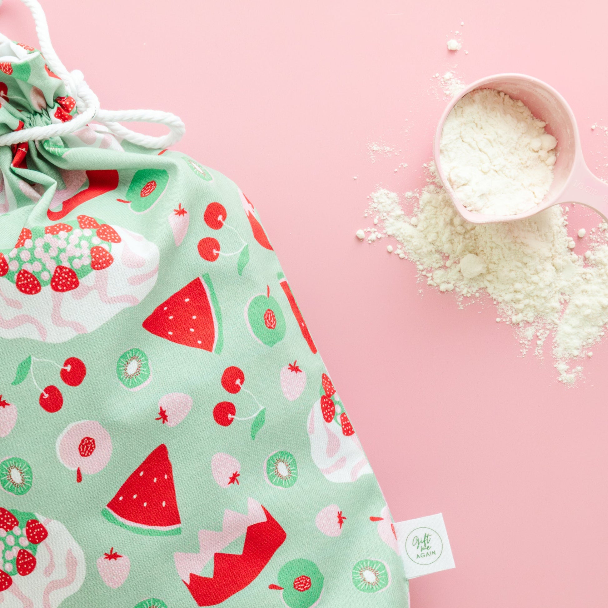 Drawstring gift bag with dessert pattern on a pink background