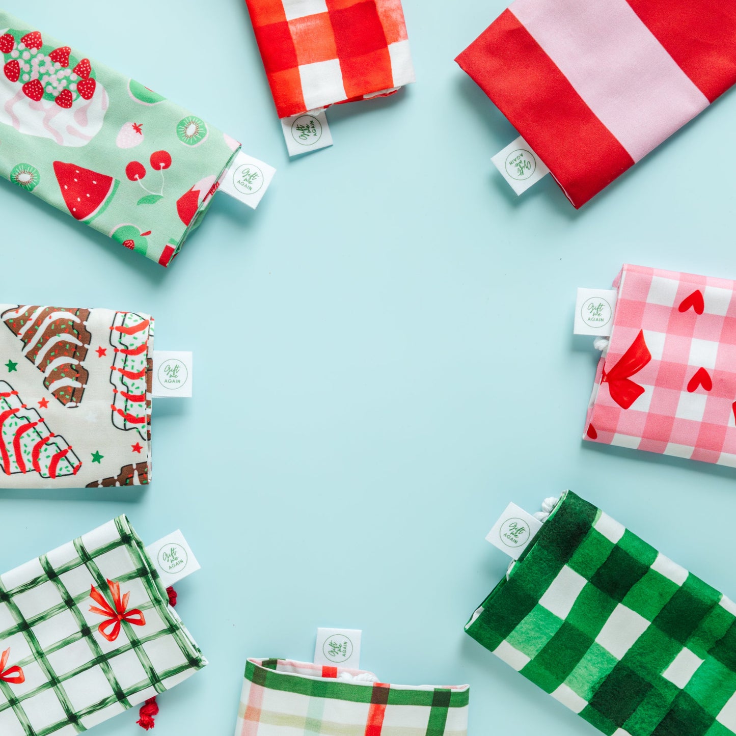 Various patterned fabric gift bags on a light blue background