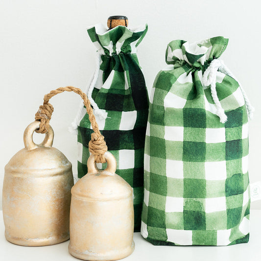 Three green and white check drawstring gift bags with rope handles, arranged on a clean white background.
