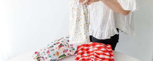 Person folding a fabric gift bag in a star print