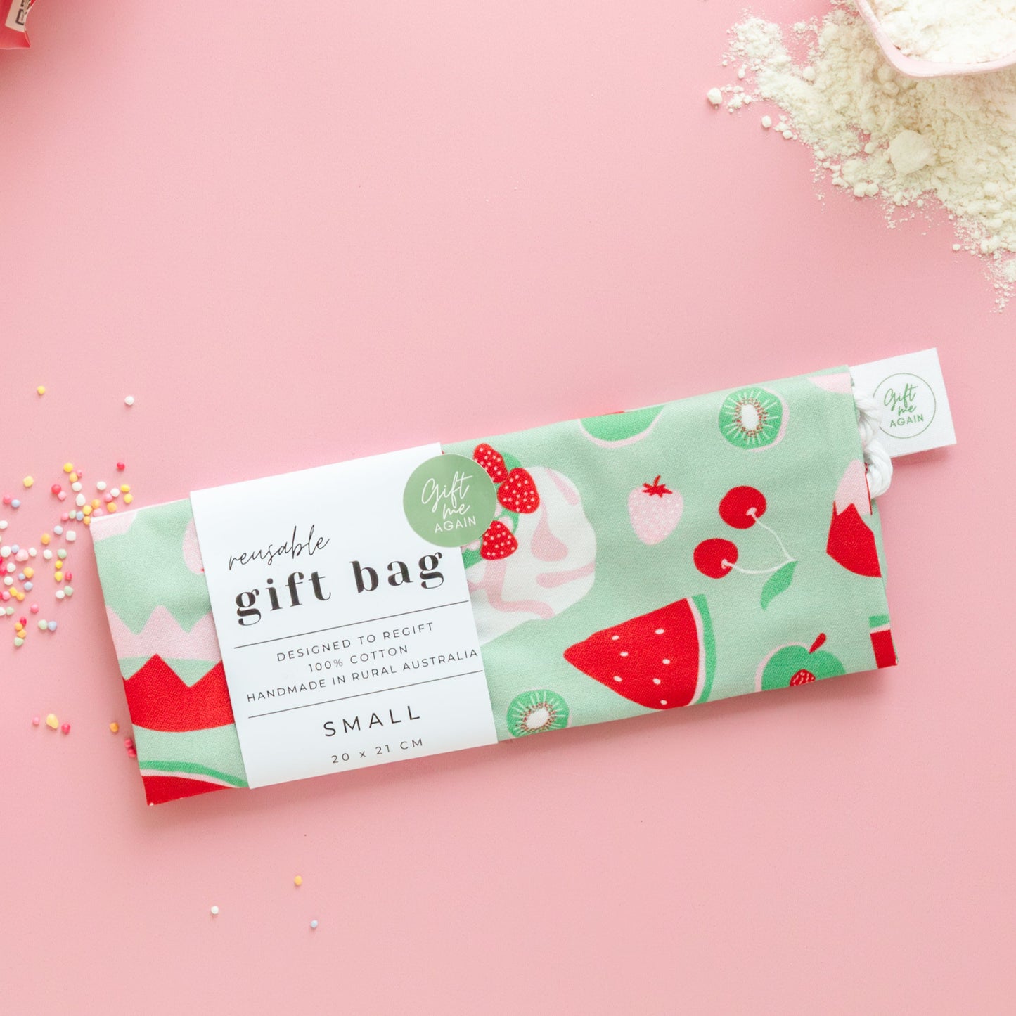 Fabric gift bag with strawberry design on a pink background