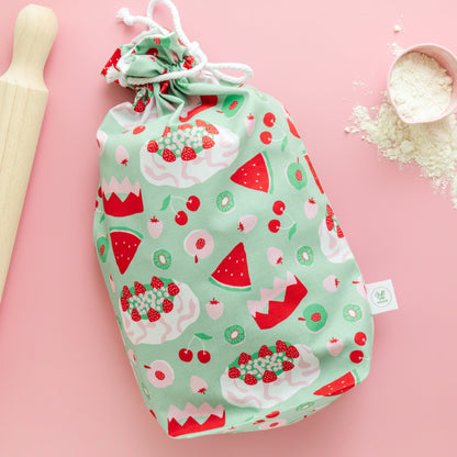 Fabric gift bag with a watermelon, pavlova and fruit pattern on a pink background