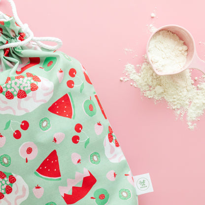 Drawstring gift bag with dessert pattern on a pink background
