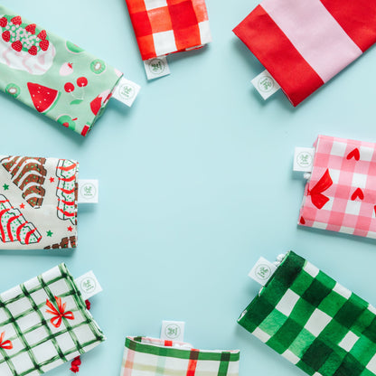 Various patterned fabric gift bags on a light blue background