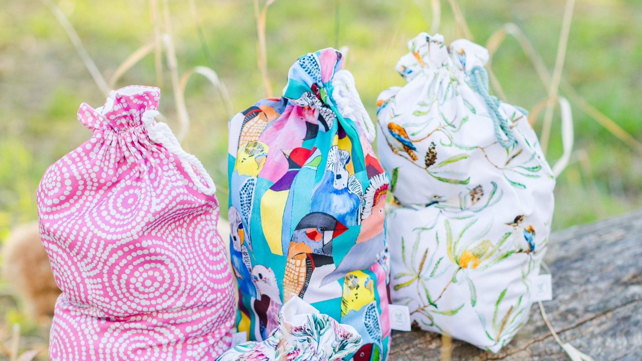 Three fabric bags with different patterns on a natural background